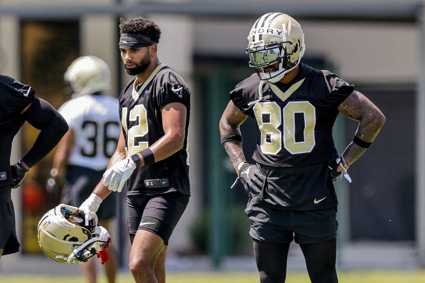 New Orleans Saints first round draft pick, wide receiver Chris Olave (12),  high fives quarterback Jameis